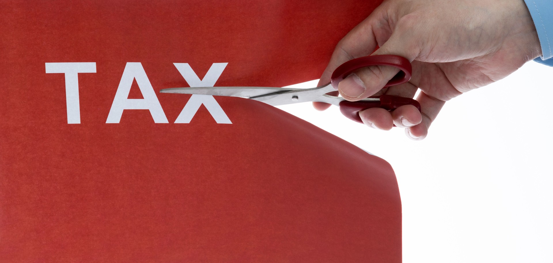 Cutting off the word tax with scissors